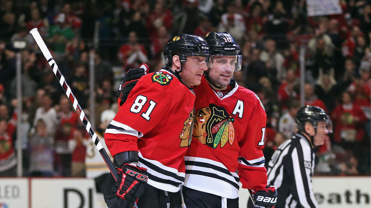 CHICAGO, IL - JANUARY 19: Marian Hossa #81 and Patrick Sharp #10 of the Chicago Blackhawks celebrates Hossa's first period goal against the Boston Bruins at the United Center on January 19, 2014 in Chicago, Illinois.