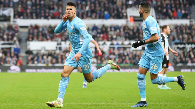 NEWCASTLE UPON TYNE, ENGLAND - DECEMBER 19: Joao Cancelo of Manchester City celebrates after scoring their sides second goal during the Premier League match between Newcastle United and Manchester City at St. James Park on December 19, 2021 in Newcastle upon Tyne, England.