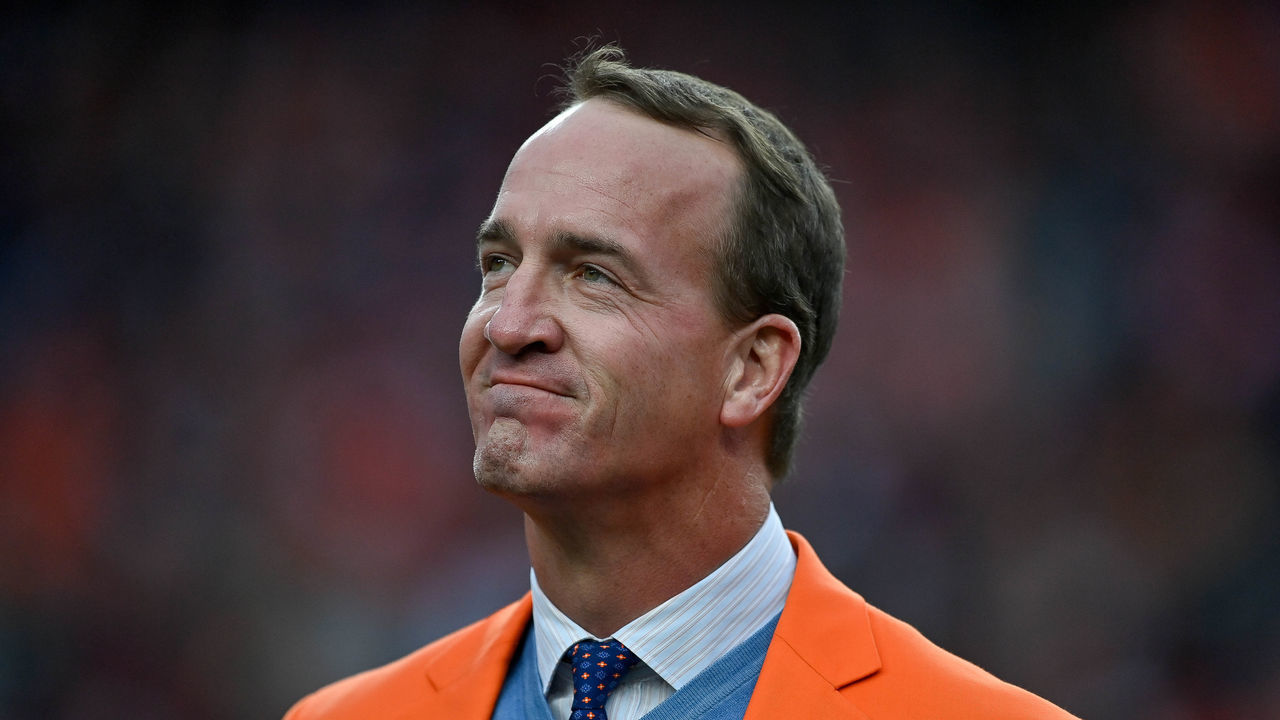 DENVER, CO - OCTOBER 31: Former Denver Broncos quarterback Peyton Manning looks on during a ceremony to reveal his name on the stadium Ring of Fame at halftime during a game between the Denver Broncos and the Washington Football Team at Empower Field at Mile High on October 31, 2021 in Denver, Colorado.