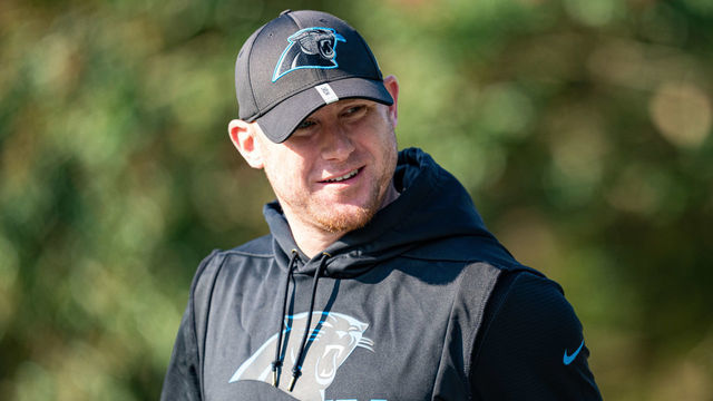 SPARTANBURG, SOUTH CAROLINA - AUGUST 08: Joe Brady of the Carolina Panthers walks onto the field during their training camp on August 08, 2021 in Spartanburg, South Carolina.