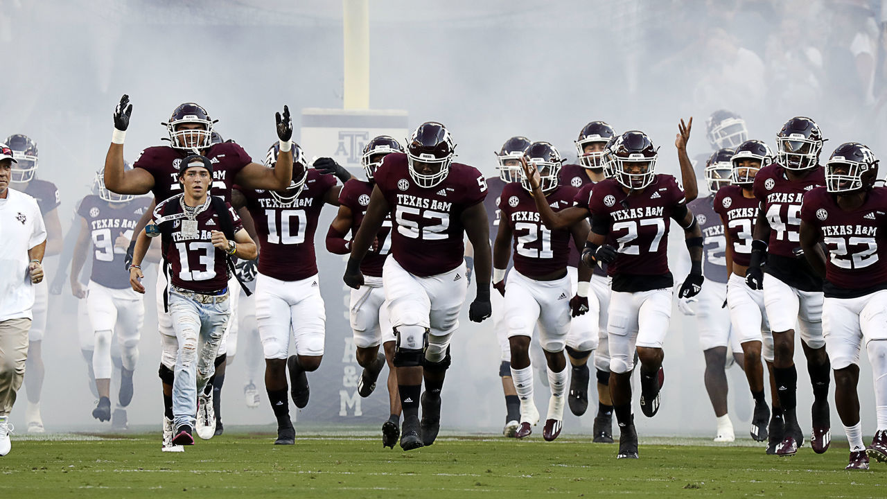 COLLEGE STATION, TEXAS - OCTOBER 02: head coach Jimbo Fisher of the Texas A&M Aggies brings his team onto the field against the Mississippi State Bulldogs at Kyle Field on October 02, 2021 in College Station, Texas.