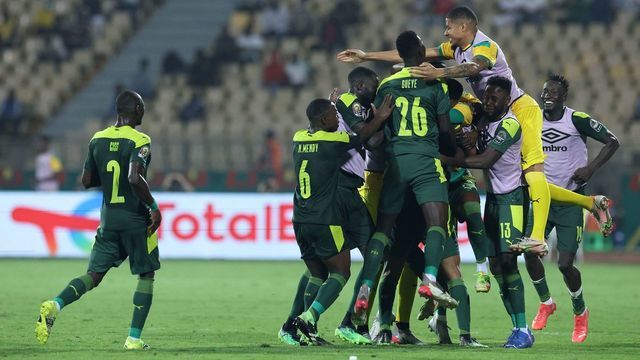 Senegal's players celebrate their team's first goal during the Africa Cup of Nations (CAN) 2021 semi final football match between Burkina Faso and Senegal at Stade Ahmadou-Ahidjo in Yaounde on February 2, 2022.