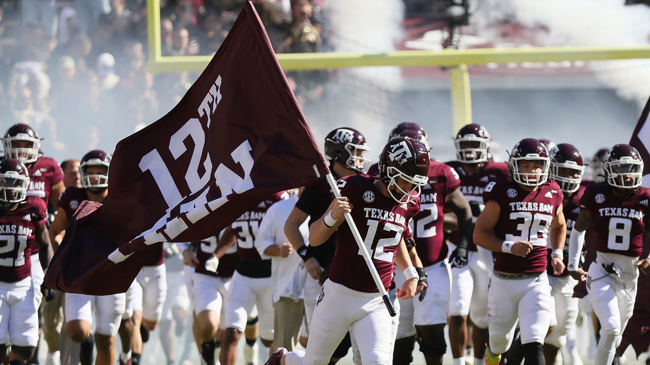 COLLEGE STATION, TEXAS - NOVEMBER 06: Connor Choate #12 of the Texas A&M Aggies runs onto the field with the 12th Man Flag against the Auburn Tigers at Kyle Field on November 06, 2021 in College Station, Texas.