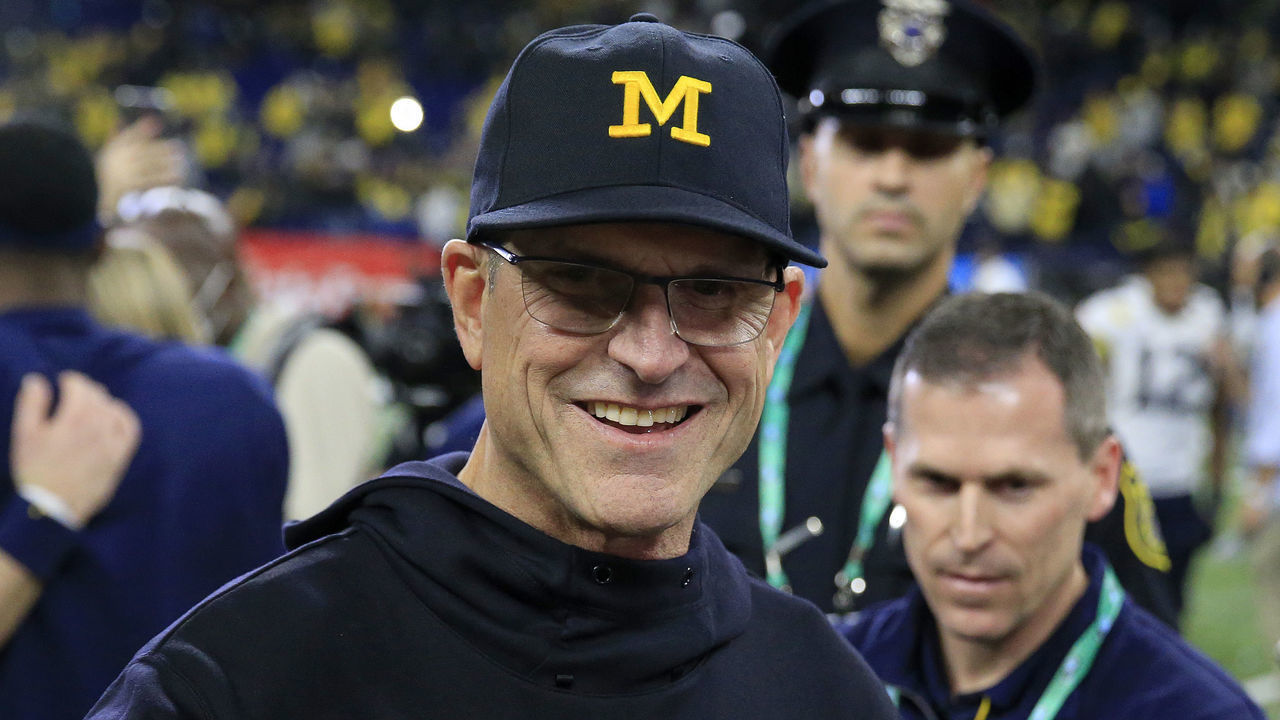 INDIANAPOLIS, INDIANA - DECEMBER 04: Head coach Jim Harbaugh of the Michigan Wolverines walks on the field after winning the Big Ten Football Championship game against the the Iowa Hawkeyes at Lucas Oil Stadium on December 04, 2021 in Indianapolis, Indiana.