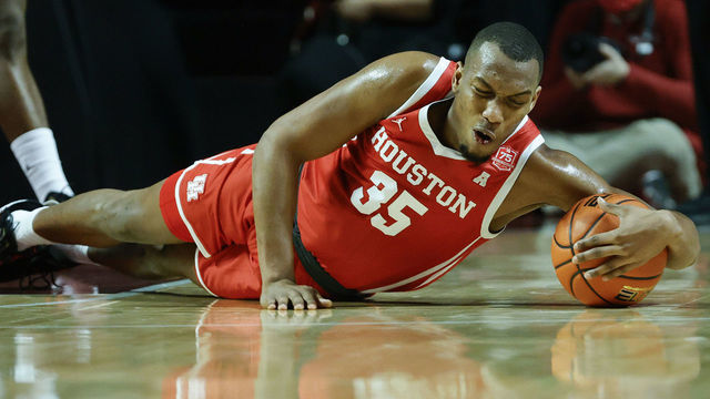PHILADELPHIA, PENNSYLVANIA - JANUARY 02: Fabian White Jr. #35 of the Houston Cougars goes to the floor for a loose ball during the first half against the Temple Owls at Liacouras Center on January 02, 2022 in Philadelphia, Pennsylvania.