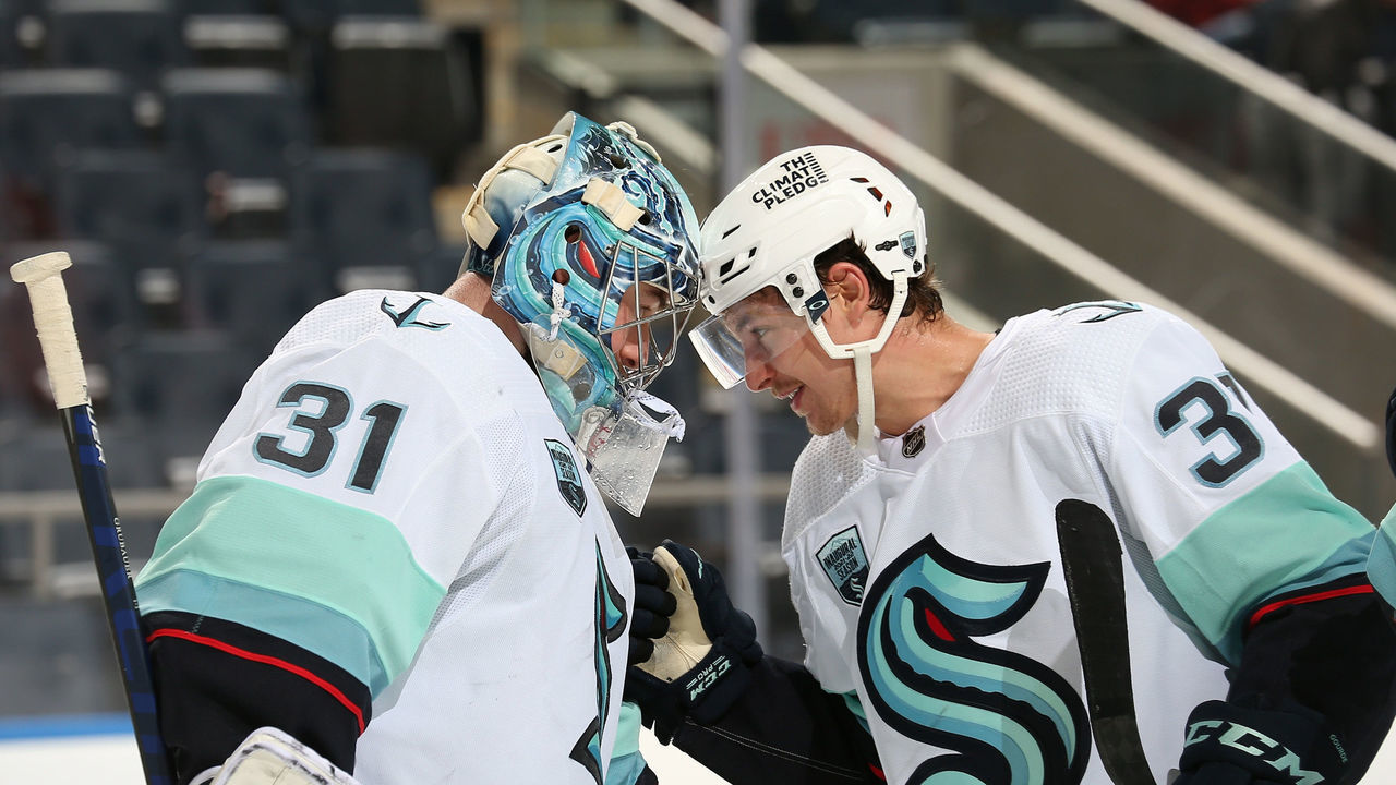 ELMONT, NY - FEBRUARY 02: Philipp Grubauer #31 and Yanni Gourde #37 of the Seattle Kraken celebrate after a 3-0 win against the New York Islanders at UBS Arena on February 2, 2022 in Elmont, New York.