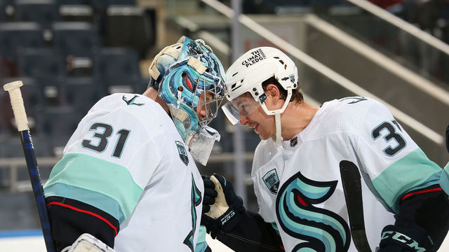ELMONT, NY - FEBRUARY 02: Philipp Grubauer #31 and Yanni Gourde #37 of the Seattle Kraken celebrate after a 3-0 win against the New York Islanders at UBS Arena on February 2, 2022 in Elmont, New York.