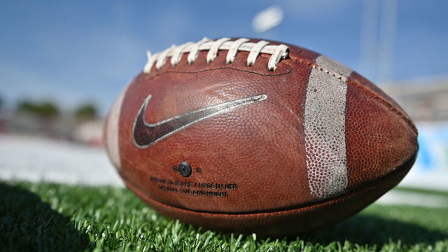 ALBUQUERQUE, NEW MEXICO - SEPTEMBER 11: A football with a Nike logo lies on the field before a game between the New Mexico State Aggies and the New Mexico Lobos at University Stadium on September 11, 2021 in Albuquerque, New Mexico. The Lobos defeated the Aggies 34-23.