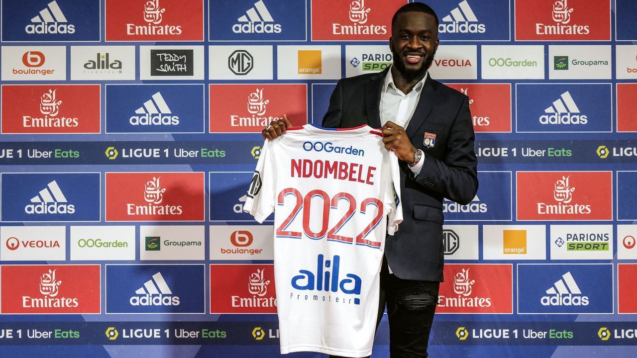 Lyons French midfielder Tanguy Ndombele shows his new jersey during a press conference at the Groupama Stadium in Decines-Charpieu, near Lyon, on February 2, 2022. - French international midfielder Tanguy Ndombele has joined Lyon on a six-months loan from Tottenham Hotspur in a deal with an option to purchase.
