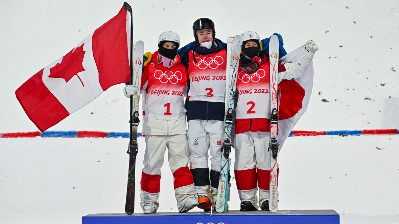 (From L to R) Silver medallist Canada's Mikael Kingsbury, gold medallist Sweden's Walter Wallberg and bronze medallist Japan's Ikuma Horishima pose during the medal ceremony after the freestyle skiing men's moguls final during the Beijing 2022 Winter Olympic Games at the Genting Snow Park A & M Stadium in Zhangjiakou on February 5, 2022.