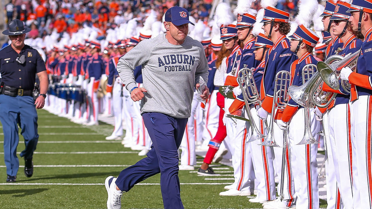 BIRMINGHAM, AL - DECEMBER 28: Auburn Tigers head coach Bryan Harsin runs off the field at halftime of the Ticket Smarter Birmingham Bowl between the Auburn Tigers and the Houston Cougars on December 28, 2021, at Protective Stadium in Birmingham, AL.