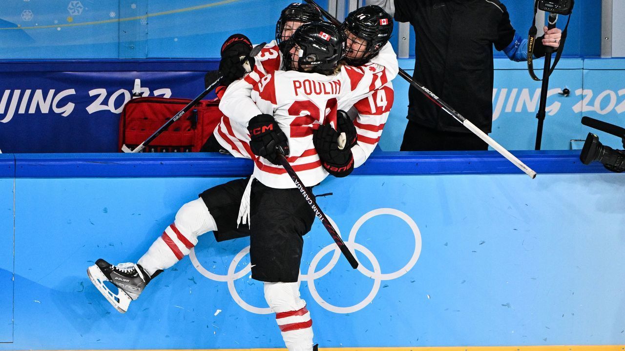 Canada's Marie-Philip Poulin (C) celebrates with teammates after scoring the goal during the women's preliminary round group A match of the Beijing 2022 Winter Olympic Games ice hockey competition between USA and Canada, at the Wukesong Sports Centre in Beijing on February 8, 2022.