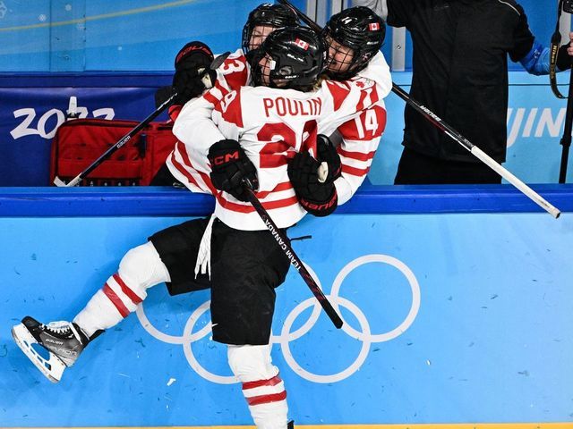 Canada's Marie-Philip Poulin (C) celebrates with teammates after scoring the goal during the women's preliminary round group A match of the Beijing 2022 Winter Olympic Games ice hockey competition between USA and Canada, at the Wukesong Sports Centre in Beijing on February 8, 2022.