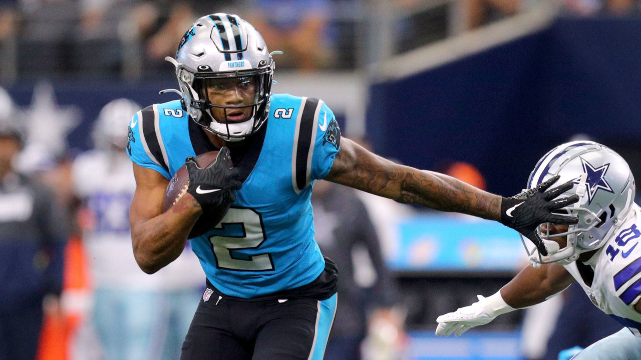 ARLINGTON, TEXAS - OCTOBER 03: D.J. Moore #2 of the Carolina Panthers avoids a tackle by Damontae Kazee #18 of the Dallas Cowboys and runs the ball during the first quarter at AT&T Stadium on October 03, 2021 in Arlington, Texas.