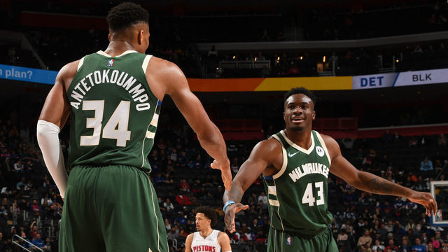 DETROIT, MI - NOVEMBER 2: Giannis Antetokounmpo #34 of the Milwaukee Bucks high fives Thanasis Antetokounmpo #43 of the Milwaukee Bucks during the game against the Detroit Pistons on November 2, 2021 at Little Caesars Arena in Detroit, Michigan. NOTE TO USER: User expressly acknowledges and agrees that, by downloading and/or using this photograph, User is consenting to the terms and conditions of the Getty Images License Agreement. Mandatory Copyright Notice: Copyright 2021 NBAE