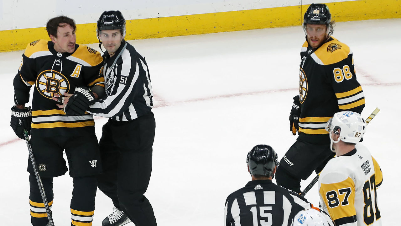 Boston - February 8: The Bruins Brad Marchand (left) has something to say to the Penguins Sidney Crosby (87) as he is escorted off the ice following a late third period incident. The Boston Bruins hosted the Pittsburgh Penguins in a regular season NHL hockey game at the TD Garden in Boston on Feb. 8, 2022.