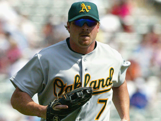 ARLINGTON, TEXAS - APRIL 11: Left fielder Jeremy Giambi #7 of the Oakland Athletics jogs to the dugout during the MLB game against the Texas Rangers at The Ballpark in Arlington, Texas on April 11, 2002. The Rangers won 7-0.