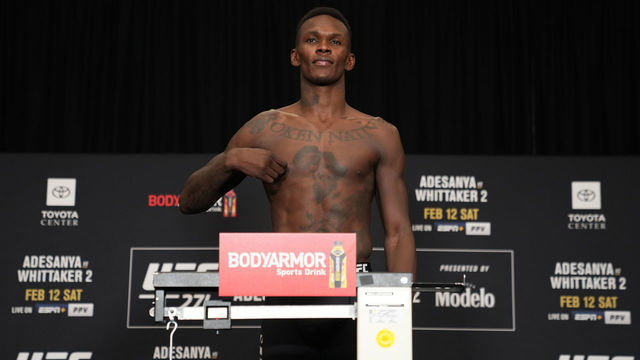 HOUSTON, TEXAS - FEBRUARY 11: Israel Adesanya of Nigeria poses on the scale during the UFC 271 official weigh-in at the Westin Oaks hotel on February 11, 2022 in Houston, Texas.