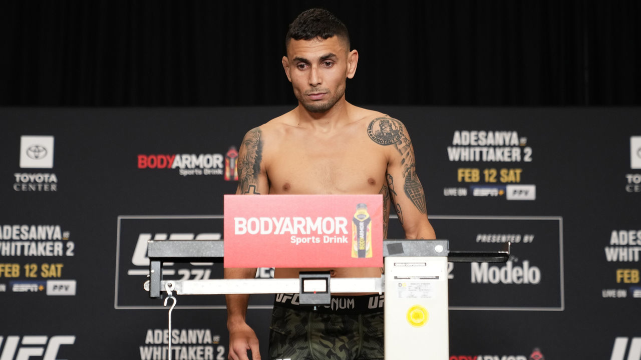 HOUSTON, TEXAS - FEBRUARY 11: Alex Perez poses on the scale during the UFC 271 official weigh-in at the Westin Oaks hotel on February 11, 2022 in Houston, Texas.