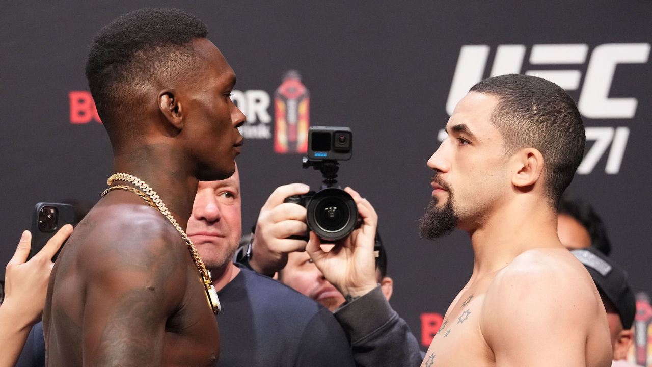 HOUSTON, TEXAS - FEBRUARY 11: (L-R) Israel Adesanya of Nigeria and Robert Whittaker of Australia face off during the UFC 271 ceremonial weigh-in at Toyota Center on February 11, 2022 in Houston, Texas.