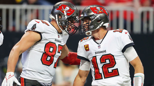 ATLANTA, GEORGIA - DECEMBER 05: (EDITOR'S NOTE: Alternate crop) Rob Gronkowski #87 of the Tampa Bay Buccaneers celebrates his touchdown against the Atlanta Falcons with teammate Tom Brady #12 during the second quarter at Mercedes-Benz Stadium on December 05, 2021 in Atlanta, Georgia.