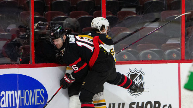 OTTAWA, ON - FEBRUARY 12: Austin Watson #16 of the Ottawa Senators bodychecks Jack Ahcan #54 of the Boston Bruins during the first period at Canadian Tire Centre on February 12, 2022 in Ottawa, Ontario, Canada.