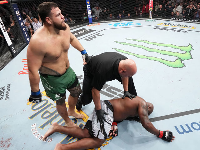 HOUSTON, TEXAS - FEBRUARY 12: (L-R) Tai Tuivasa of Australia walks off after knocking out Derrick Lewis in their heavyweight fight during the UFC 271 event at Toyota Center on February 12, 2022 in Houston, Texas.