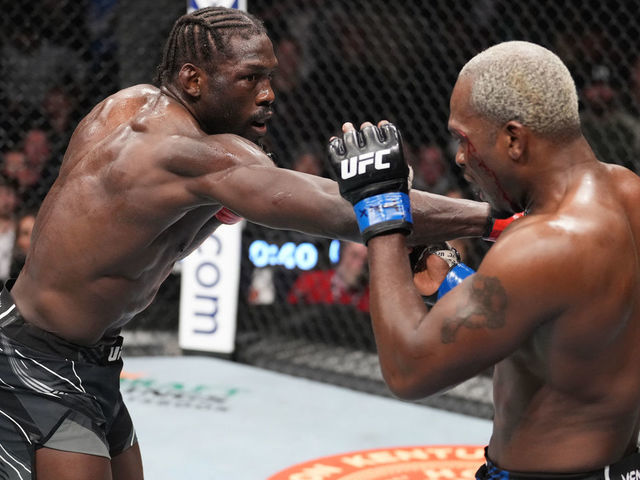 HOUSTON, TEXAS - FEBRUARY 12: (L-R) Jared Cannonier punches Derek Brunson in their middleweight fight during the UFC 271 event at Toyota Center on February 12, 2022 in Houston, Texas.