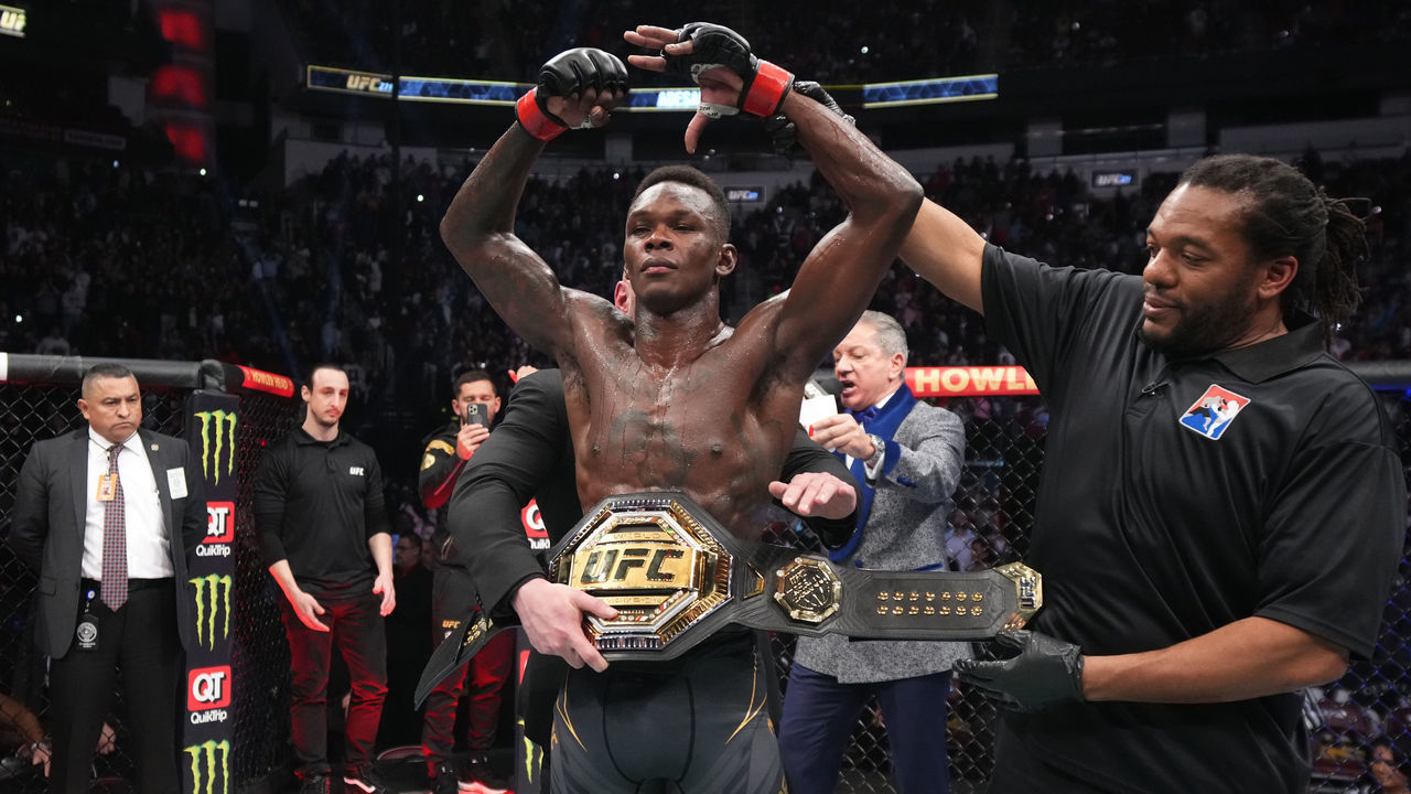 HOUSTON, TEXAS - FEBRUARY 12: Israel Adesanya of Nigeria reacts after defeating Robert Whittaker of Australia by unanimous decision in their UFC middleweight championship fight during the UFC 271 event at Toyota Center on February 12, 2022 in Houston, Texas.