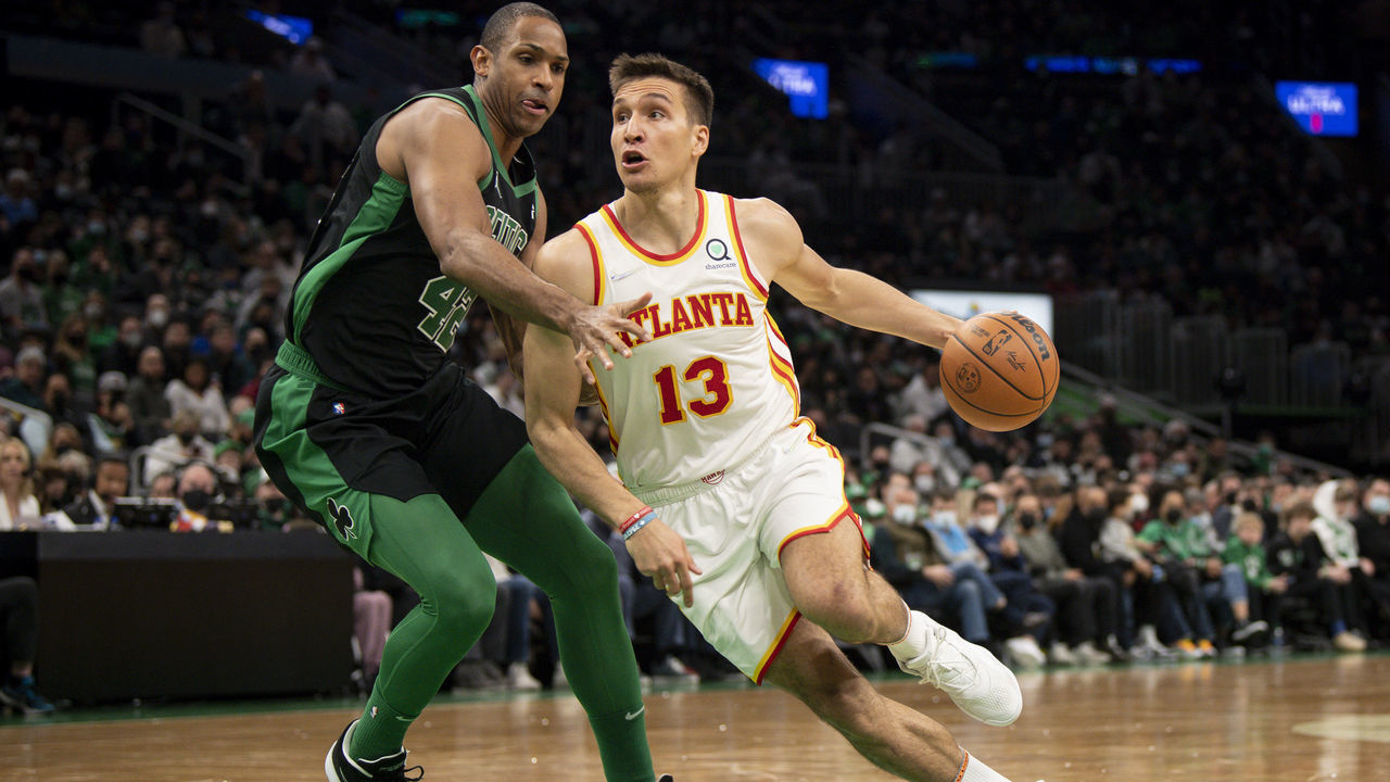 BOSTON, MASSACHUSETTS - FEBRUARY 13: Bogdan Bogdanovic #13 of the Atlanta Hawks drives to the basket against Al Horford #42 of the Boston Celtics during the first half of a game at TD Garden on February 13, 2022 in Boston, Massachusetts.