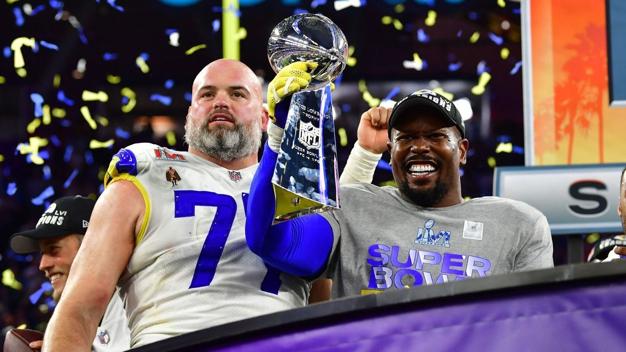 Los Angeles Rams' Andrew Whitworth (L) and Los Angeles Rams' Von Miller (R) hold the Vince Lombardi trophy after the LA Rams won Super Bowl LVI against the Cincinnati Bengals at SoFi Stadium in Inglewood, California, on February 13, 2022.