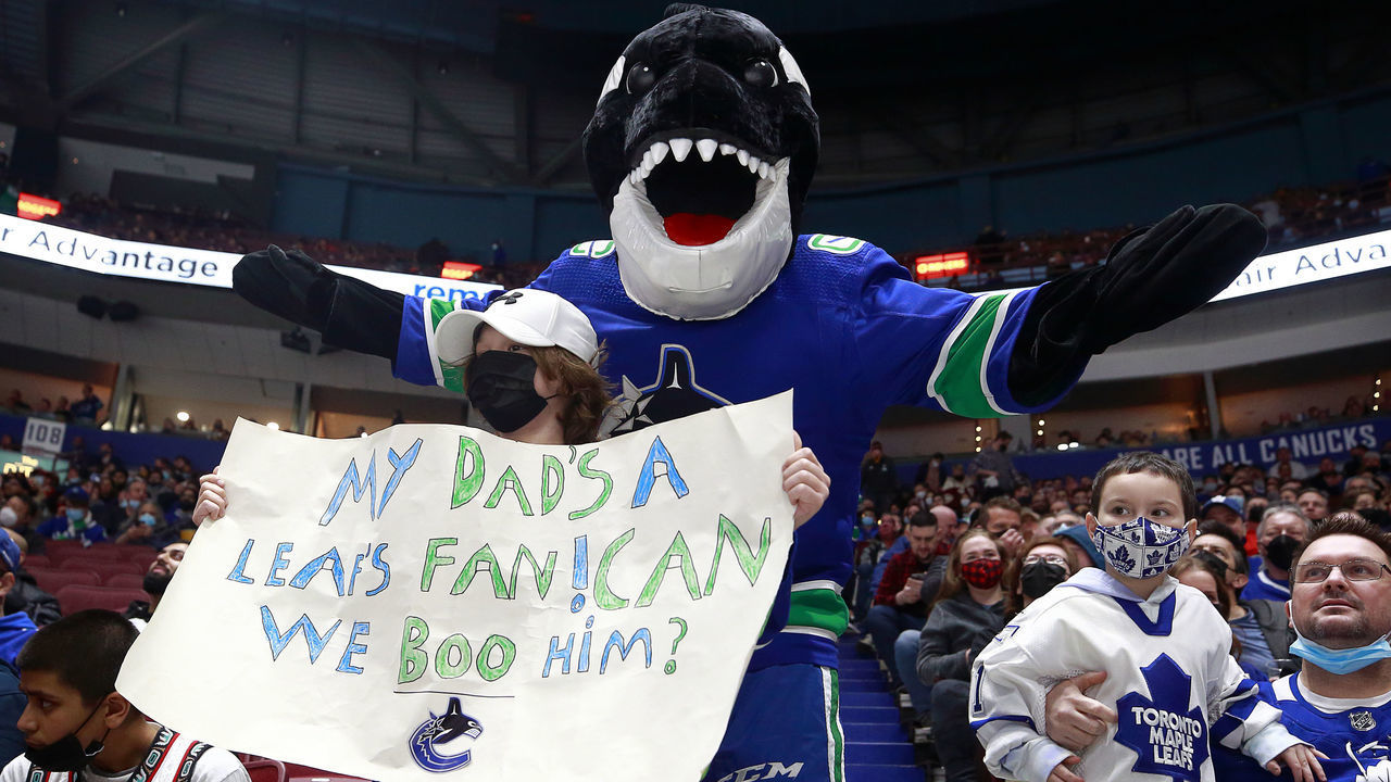 VANCOUVER, BC - FEBRUARY 12: Canucks mascot Fin and a young fan hold up a sign during the NHL game between the Vancouver Canucks and the Toronto Maple Leafs at Rogers Arena February 12, 2022 in Vancouver, British Columbia, Canada.