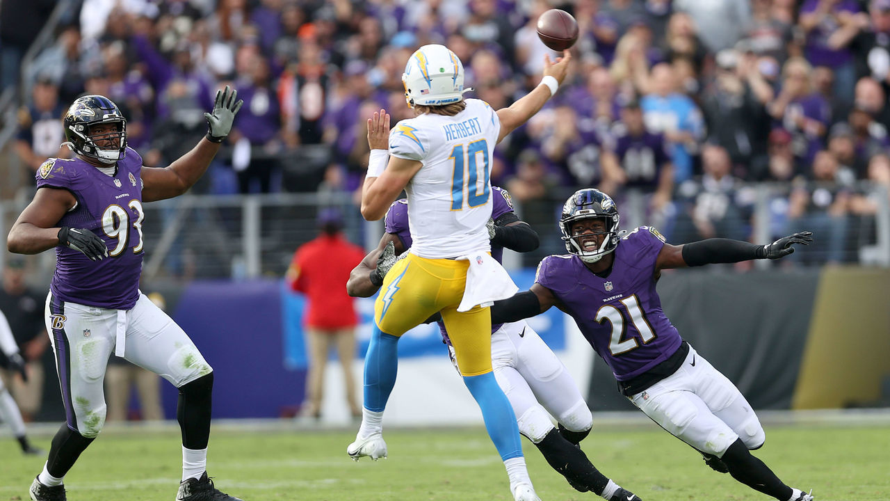 BALTIMORE, MARYLAND - OCTOBER 17: Defensive end Calais Campbell #93 and free safety Brandon Stephens #21 of the Baltimore Ravens pressure quarterback Justin Herbert #10 of the Los Angeles Chargers in the second half at M&T Bank Stadium on October 17, 2021 in Baltimore, Maryland.