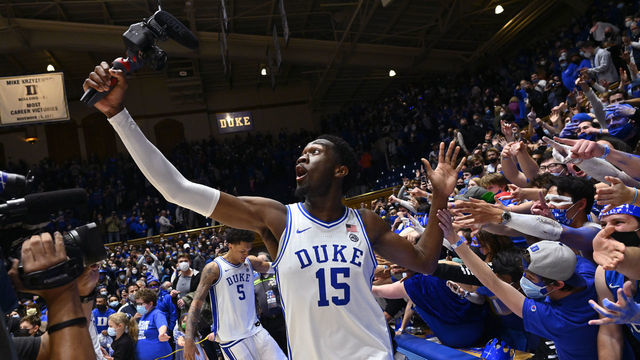 DURHAM, NORTH CAROLINA - FEBRUARY 15: Mark Williams #15 of the Duke Blue Devils celebrates with fans after scoring the game-winning basket with 0.4 seconds left against the Wake Forest Demon Deacons at Cameron Indoor Stadium on February 15, 2022 in Durham, North Carolina. Duke won 76-74.