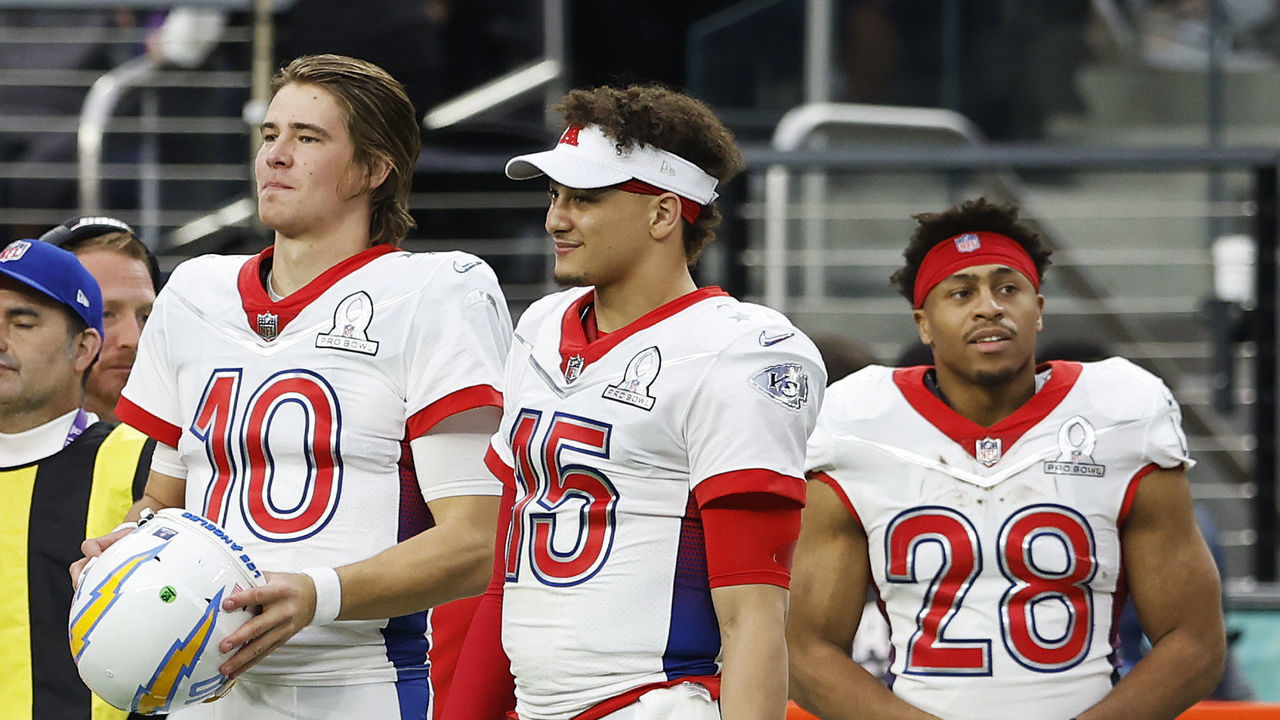 LAS VEGAS, NEVADA - FEBRUARY 06: AFC teammates Justin Herbert #10 of the Los Angeles Chargers, Patrick Mahomes #15 of the Kansas City Chiefs and Jonathan Taylor #28 of the Indianapolis Colts look on from a sideline in the second half of the 2022 NFL Pro Bowl against the NFC at Allegiant Stadium on February 06, 2022 in Las Vegas, Nevada.