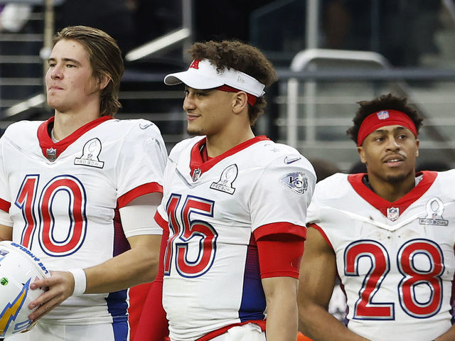 LAS VEGAS, NEVADA - FEBRUARY 06: AFC teammates Justin Herbert #10 of the Los Angeles Chargers, Patrick Mahomes #15 of the Kansas City Chiefs and Jonathan Taylor #28 of the Indianapolis Colts look on from a sideline in the second half of the 2022 NFL Pro Bowl against the NFC at Allegiant Stadium on February 06, 2022 in Las Vegas, Nevada.