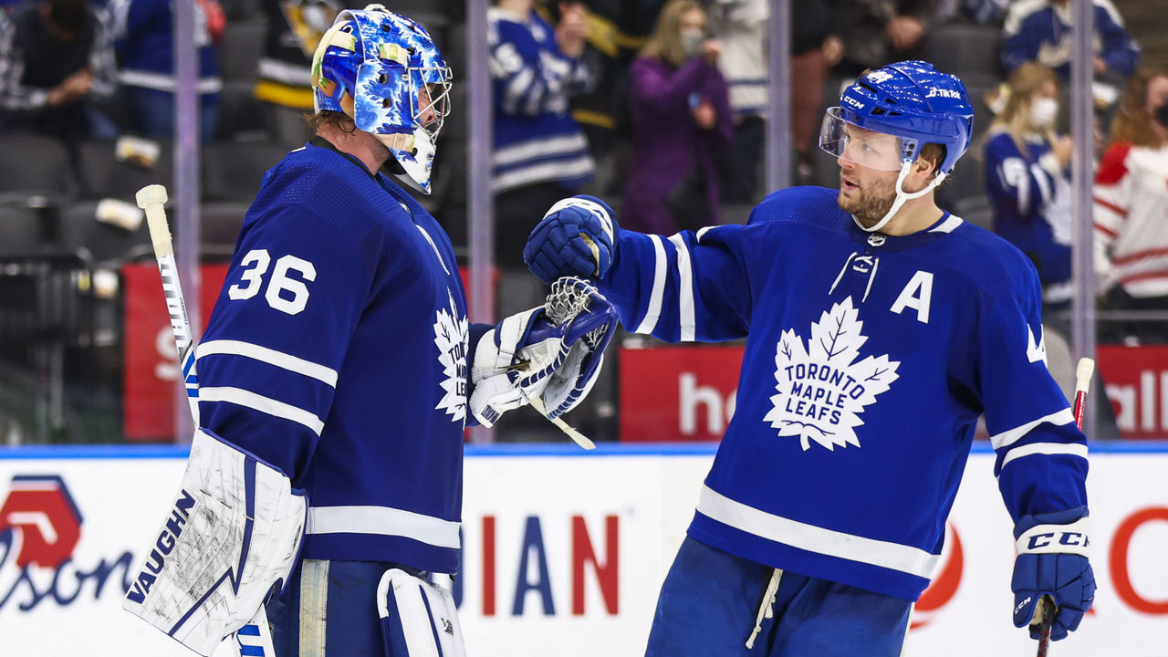 TORONTO, ON - FEBRUARY 17: Jack Campbell #36 of the Toronto Maple Leafs celebrates a win against the Pittsburgh Penguins with teammates Morgan Rielly #44 at the Scotiabank Arena on February 17, 2022 in Toronto, Ontario, Canada.