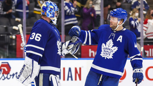 TORONTO, ON - FEBRUARY 17: Jack Campbell #36 of the Toronto Maple Leafs celebrates a win against the Pittsburgh Penguins with teammates Morgan Rielly #44 at the Scotiabank Arena on February 17, 2022 in Toronto, Ontario, Canada.