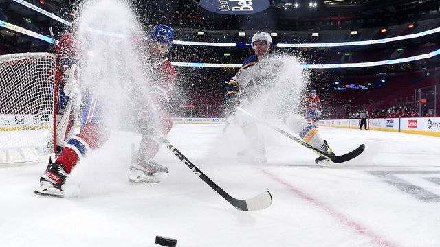 MONTREAL, QC - FEBRUARY 17: Brett Kulak #77 of the Montreal Canadiens controls the puck against Brandon Saad #20 of the St. Louis Blues in the NHL game at the Bell Centre on February 17, 2022 in Montreal, Quebec, Canada.