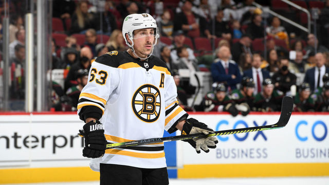 GLENDALE, ARIZONA - JANUARY 28: Brad Marchand #63 of the Boston Bruins gets ready during a face off against the Arizona Coyotes at Gila River Arena on January 28, 2022 in Glendale, Arizona.