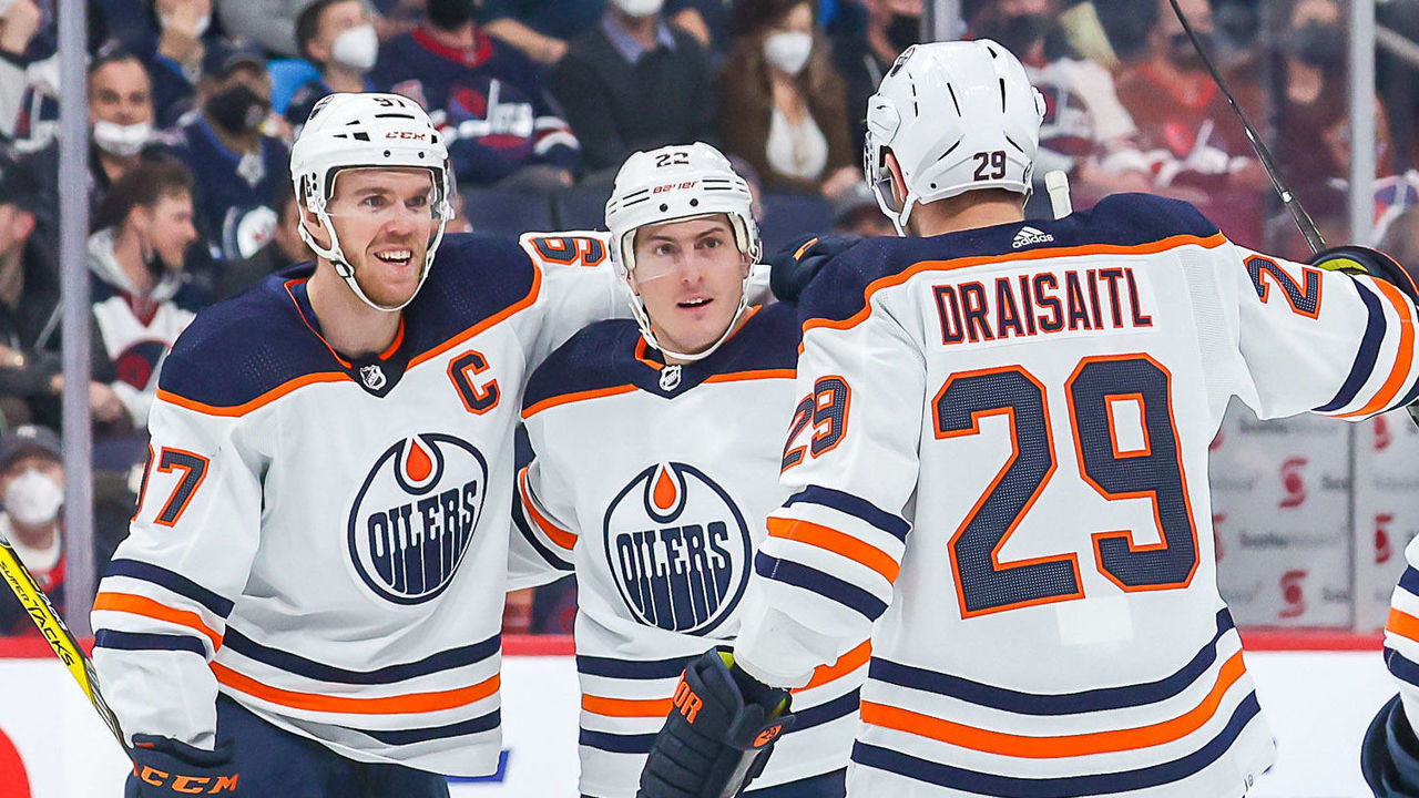 WINNIPEG, MB - FEBRUARY 19: Connor McDavid #97, Tyson Barrie #22, Leon Draisaitl #29 and Ryan Nugent-Hopkins #93 of the Edmonton Oilers celebrate a first period goal against the Winnipeg Jets at the Canada Life Centre on February 19, 2022 in Winnipeg, Manitoba, Canada.
