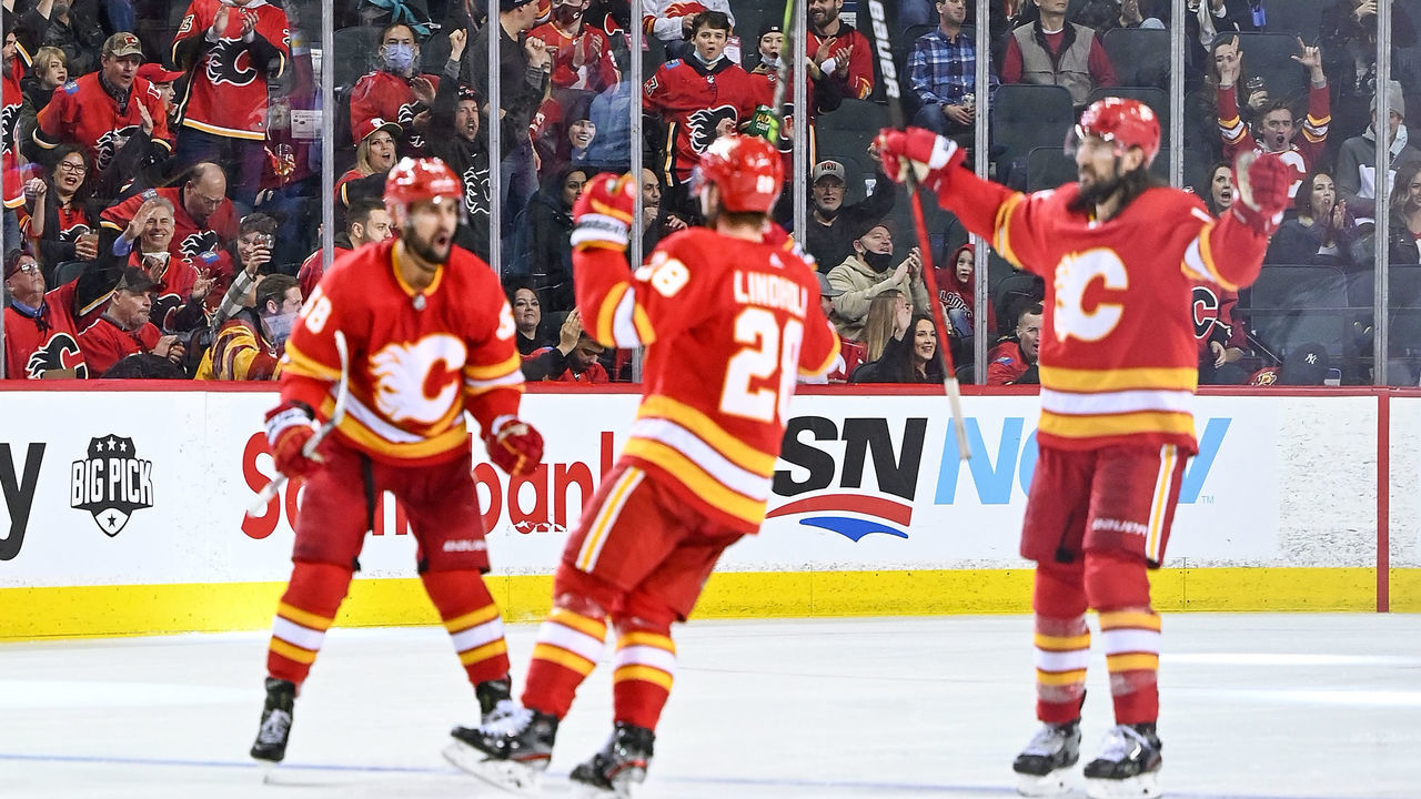CALGARY, AB - FEBRUARY 19: Calgary Flames fans celebrate a goal by Calgary Flames Center Elias Lindholm (28) during the third period of an NHL game where the Calgary Flames hosted the Seattle Kraken on February 19, 2022, at the Scotiabank Saddledome in Calgary, AB.