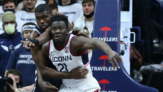 STORRS, CT - JANUARY 25: UConn Huskies forward Adama Sanogo (21) battle for position against Georgetown Hoyas center Timothy Ighoefe (5) during a college basketball game between Georgetown Hoyas and UConn Huskies on January 25, 2022, at Harry A. Gampel Pavilion in Storrs, CT.