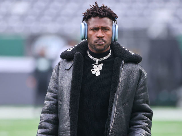 EAST RUTHERFORD, NJ - JANUARY 02: Tampa Bay Buccaneers wide receiver Antonio Brown (81) on the field in a Balenciaga jacket and a diamond Bee necklace prior to the National Football League game between the New York Jets and the Tampa Bay Buccaneers on January 2, 2022 at MetLife Stadium in East Rutherford, NJ.