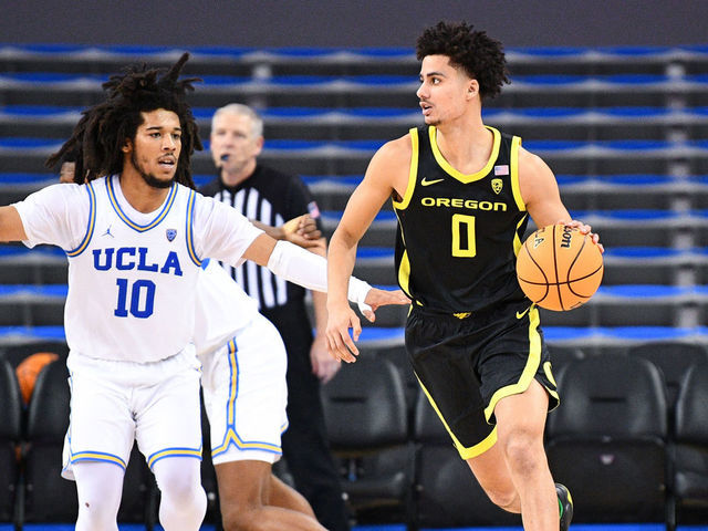 LOS ANGELES, CA - JANUARY 13: Oregon Ducks guard Will Richardson (0) guarded by UCLA Bruins guard Tyger Campbell (10) during a college basketball game between the Oregon Ducks and the UCLA Bruins on January 13, 2022, at Pauley Pavilion in Los Angeles, CA.