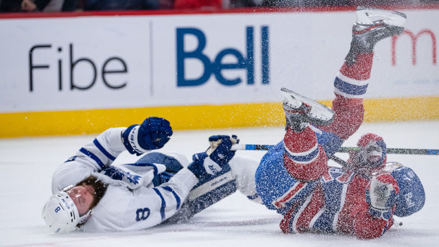 MONTREAL, QC - FEBRUARY 21: Chris Wideman (20) of the Montreal Canadiens collides with Jake Muzzin (8) of the Toronto Maple Leafs during the second period of the NHL game between the Toronto Maple Leafs and the Montreal Canadiens on February 21, 2022, at the Bell Centre in Montreal, QC
