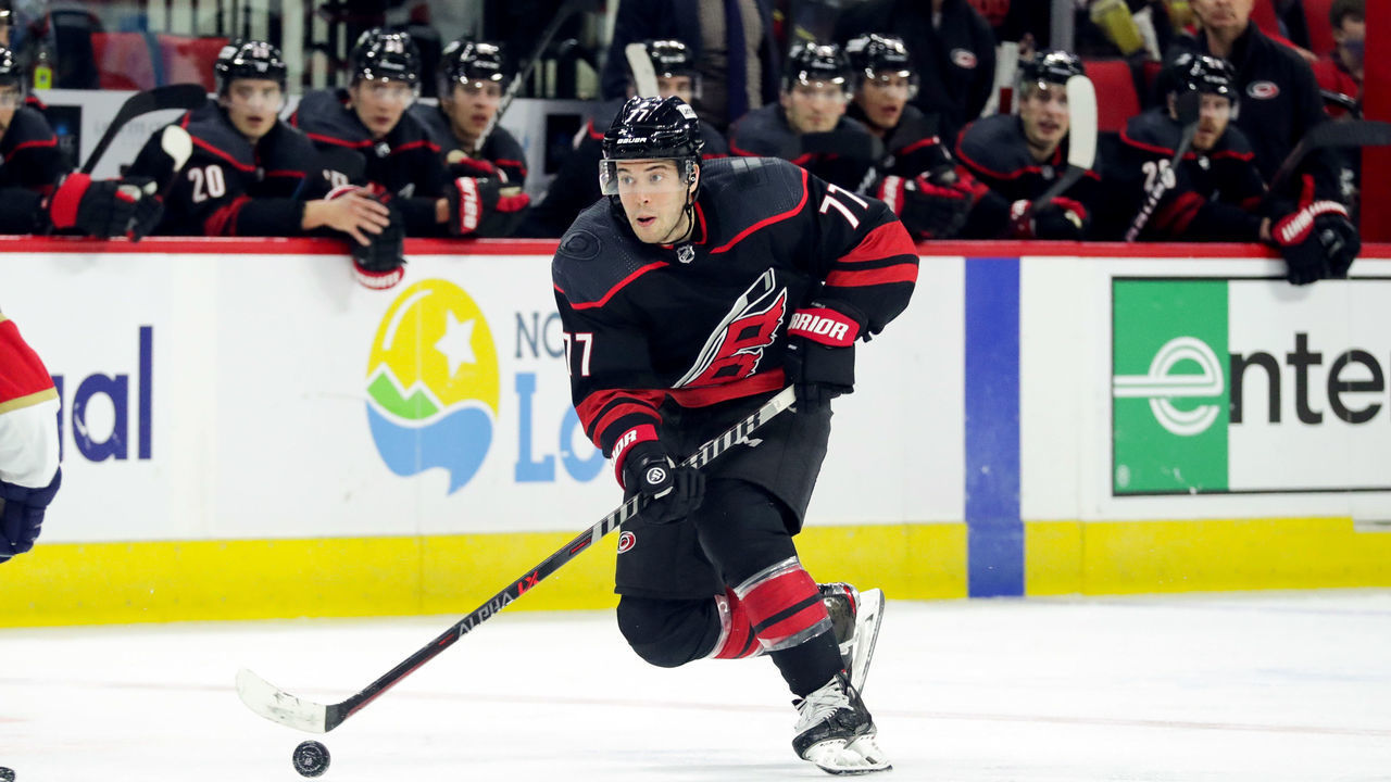 RALEIGH, NC - FEBRUARY 16: Tony DeAngelo #77 of the Carolina Hurricanes skates with the puck during an NHL game against the Florida Panthers on February 16, 2022 at PNC Arena in Raleigh, North Carolina.