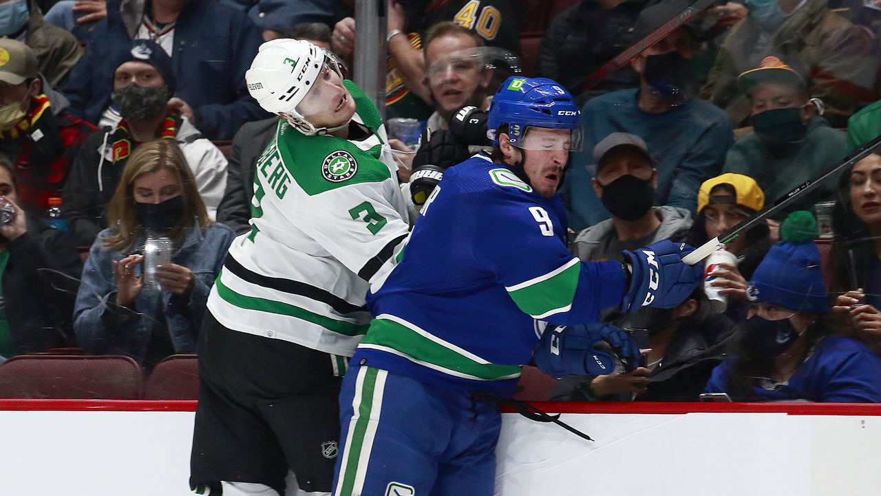 VANCOUVER, BC - NOVEMBER 7: J.T. Miller #9 of the Vancouver Canucks checks John Klingberg #3 of the Dallas Stars during their NHL game at Rogers Arena November 7, 2021 in Vancouver, British Columbia, Canada.