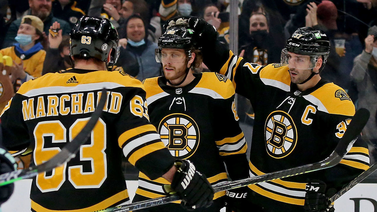 BOSTON, MA - February 1: Boston Bruins right wing David Pastrnak (88) celebrates his goal with Boston Bruins center Patrice Bergeron (37) and Boston Bruins left wing Brad Marchand (63) as the Bruins take on the Kraken at the Garden on February 1, 2022 in BOSTON, Massachusetts. (Staff Photo By Stuart Cahill/Boston Herald)