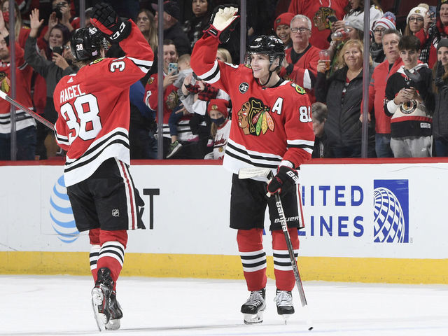 Chicago Blackhawks center Kirby Dach, right, celebrates his tying